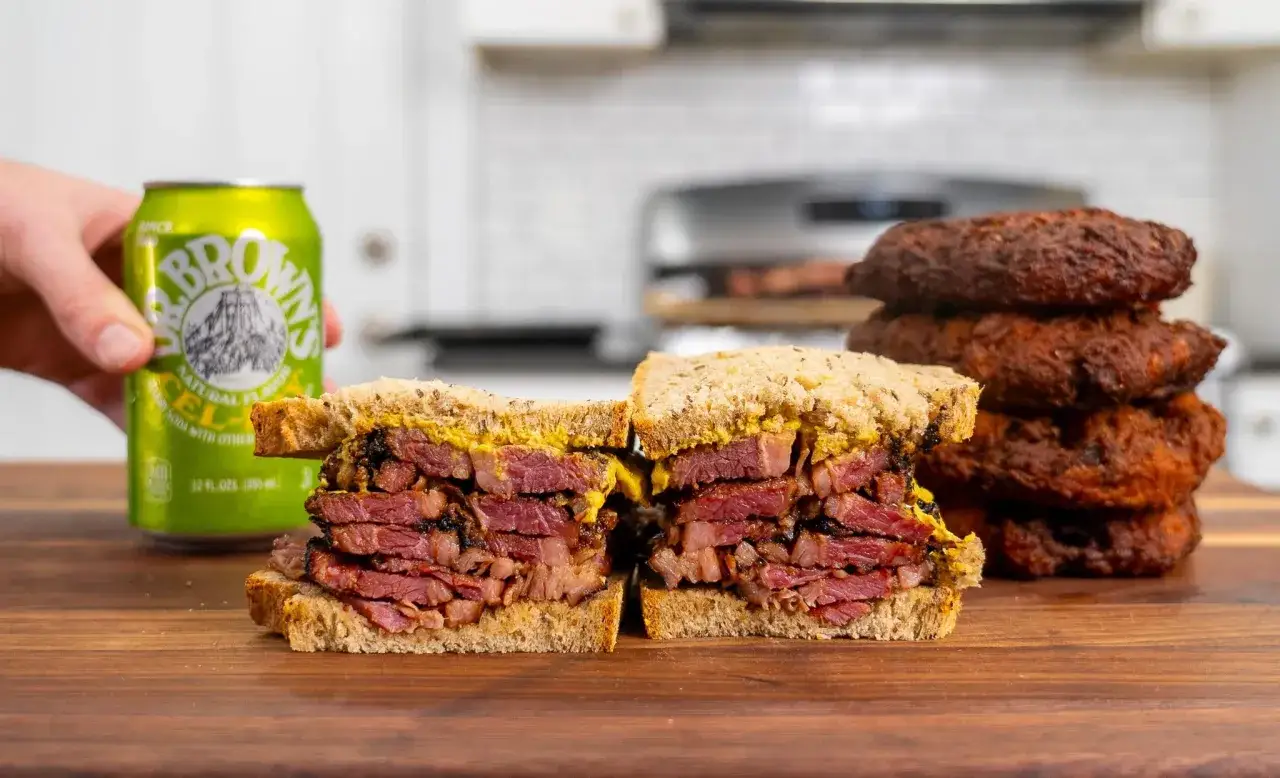 En rej&auml;l pastrami-macka med senap, bredvid en burk Dr. Brown's. Perfekt f&ouml;r ett snabbt pastrami recept.