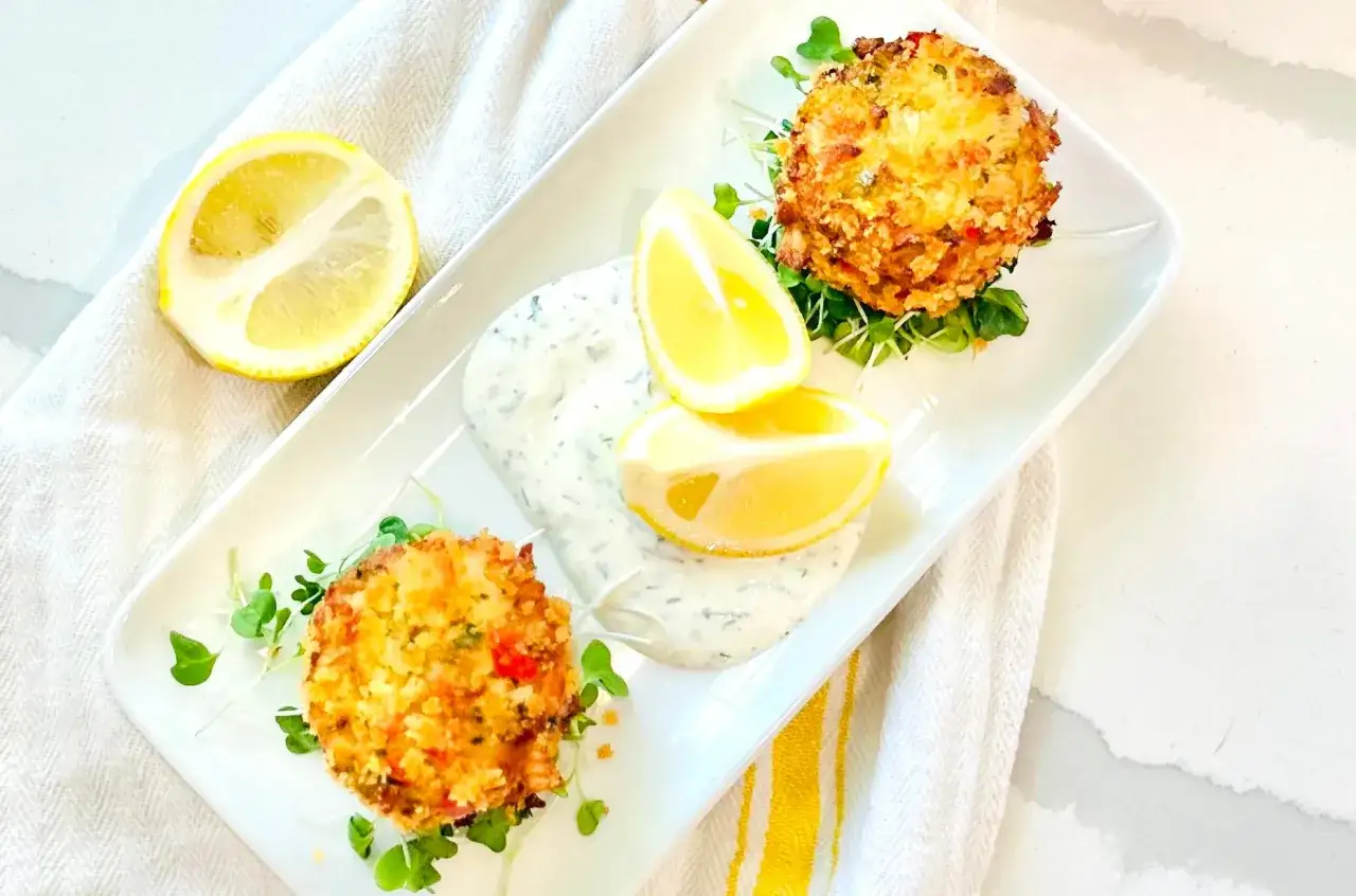 Tv&aring; gyllene krabbkakor serveras med en kr&auml;mig s&aring;s, citronklyftor och f&auml;rska groddar. Ett perfekt krabba recept f&ouml;r en l&auml;tt lunch.