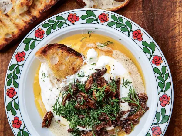 Krämig burrata med smörstekta kantareller och dill, serverad med rostat bröd. En härlig höstfavorit.